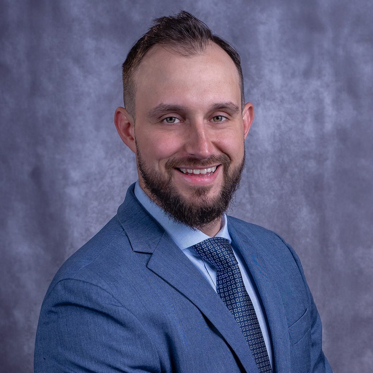 A man in a blue suit and tie.